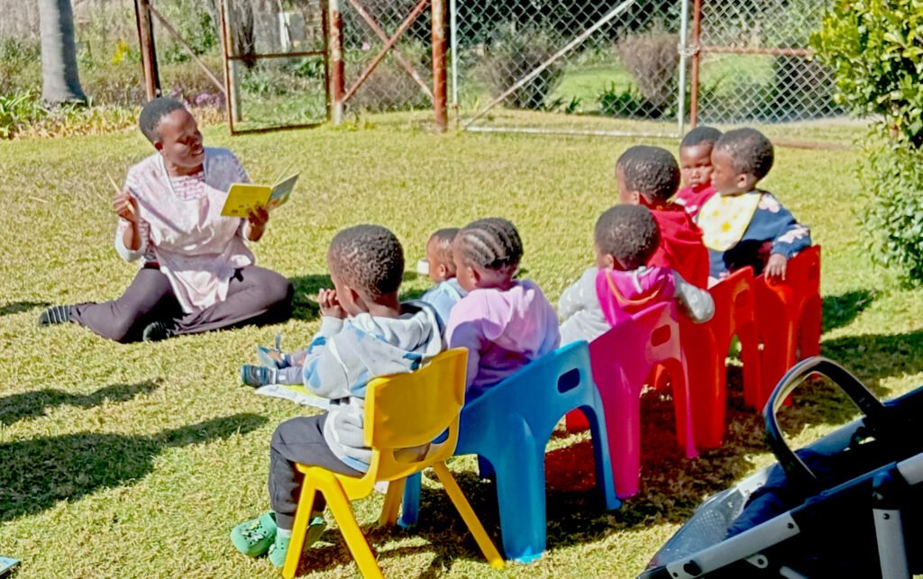 Story time in the warm wintery sun with Aunty Tema